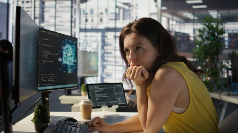 Woman in office working on threat intelligence monitoring