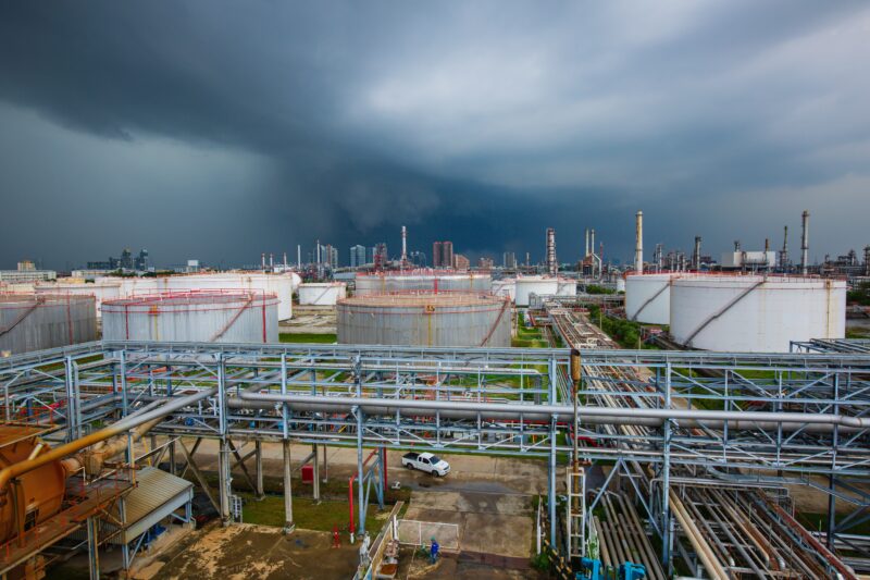Industrial facility exposed to severe weather, illustrating climate and natural hazard risks to critical infrastructure
