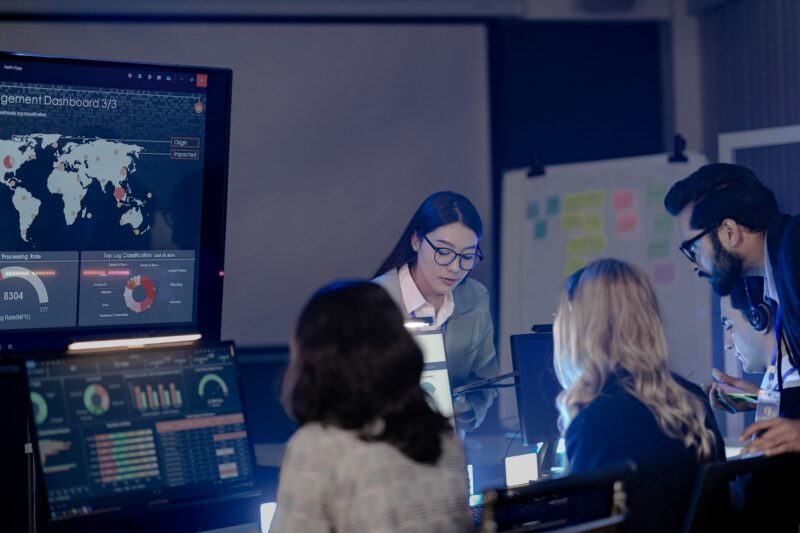 Risk management team reviewing catastrophe and climate risk modeling data on an analytics dashboard.